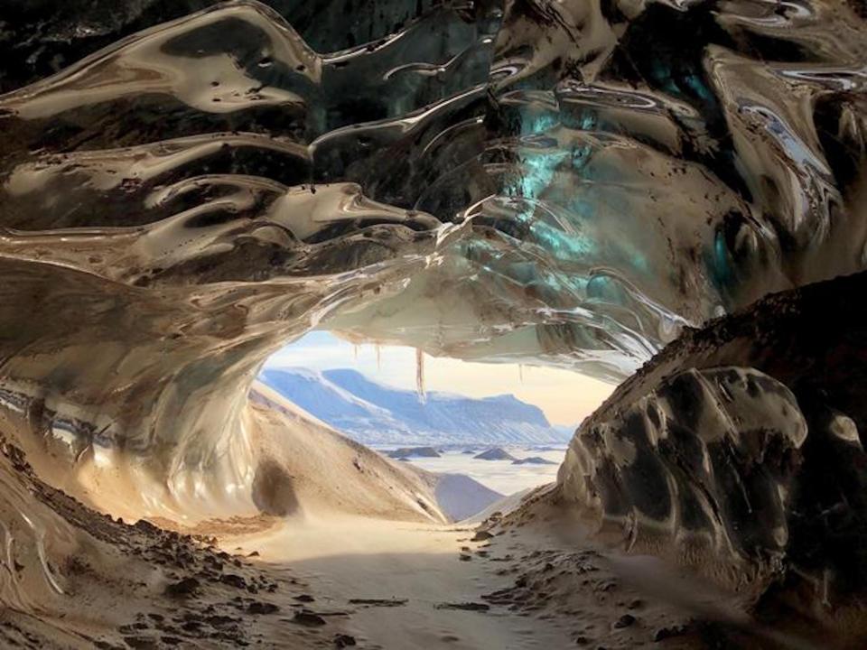 A picture shows the view from inside a glacier cave in Svalbard, Norway.