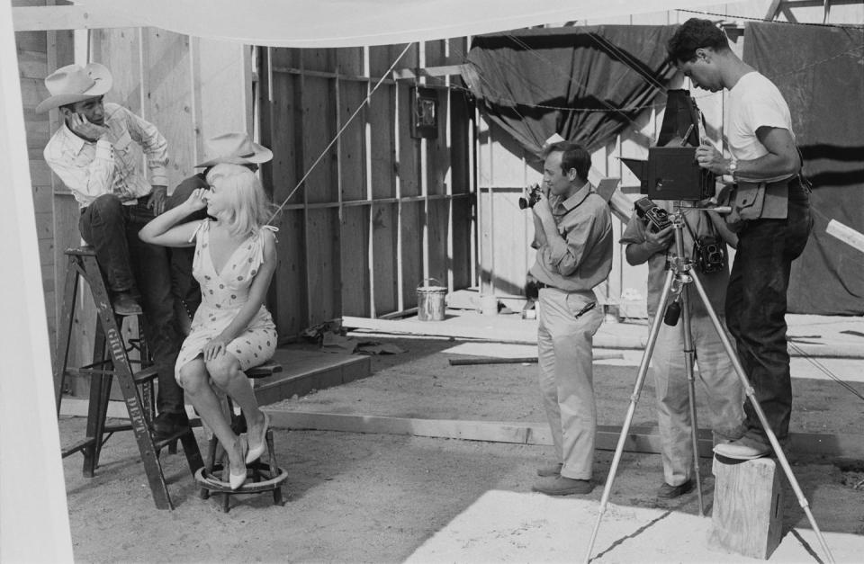 <p>Film photographers set up a shot for Marilyn and her co-stars Clark Gable and Montgomery Clift during the shooting of <a href="https://www.amazon.com/Misfits-Clark-Gable/dp/B00FJVBSP6/ref=sr_1_3?keywords=the+misfits&qid=1562959687&s=gateway&sr=8-3&tag=syn-yahoo-20&ascsubtag=%5Bartid%7C10050.g.28612852%5Bsrc%7Cyahoo-us" rel="nofollow noopener" target="_blank" data-ylk="slk:The Misfits;elm:context_link;itc:0;sec:content-canvas" class="link "><em>The Misfits</em></a>. The screenplay was written by her husband, Arthur Miller. It was Marilyn's last completed film. </p>