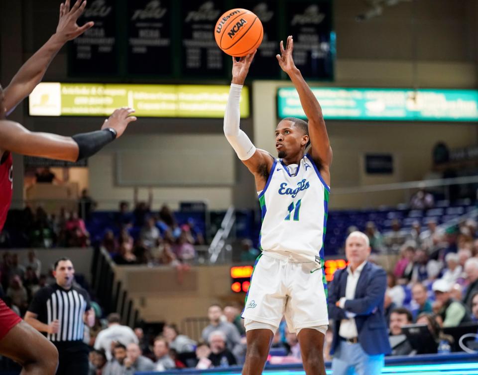 Florida Gulf Coast Eagles guard Isaiah Thompson (11) shoots a three point basket during the second half of an ASUN conference game against the Jacksonville State Gamecocks at Alico Arena in Fort Myers on Thursday, Jan. 19, 2023.