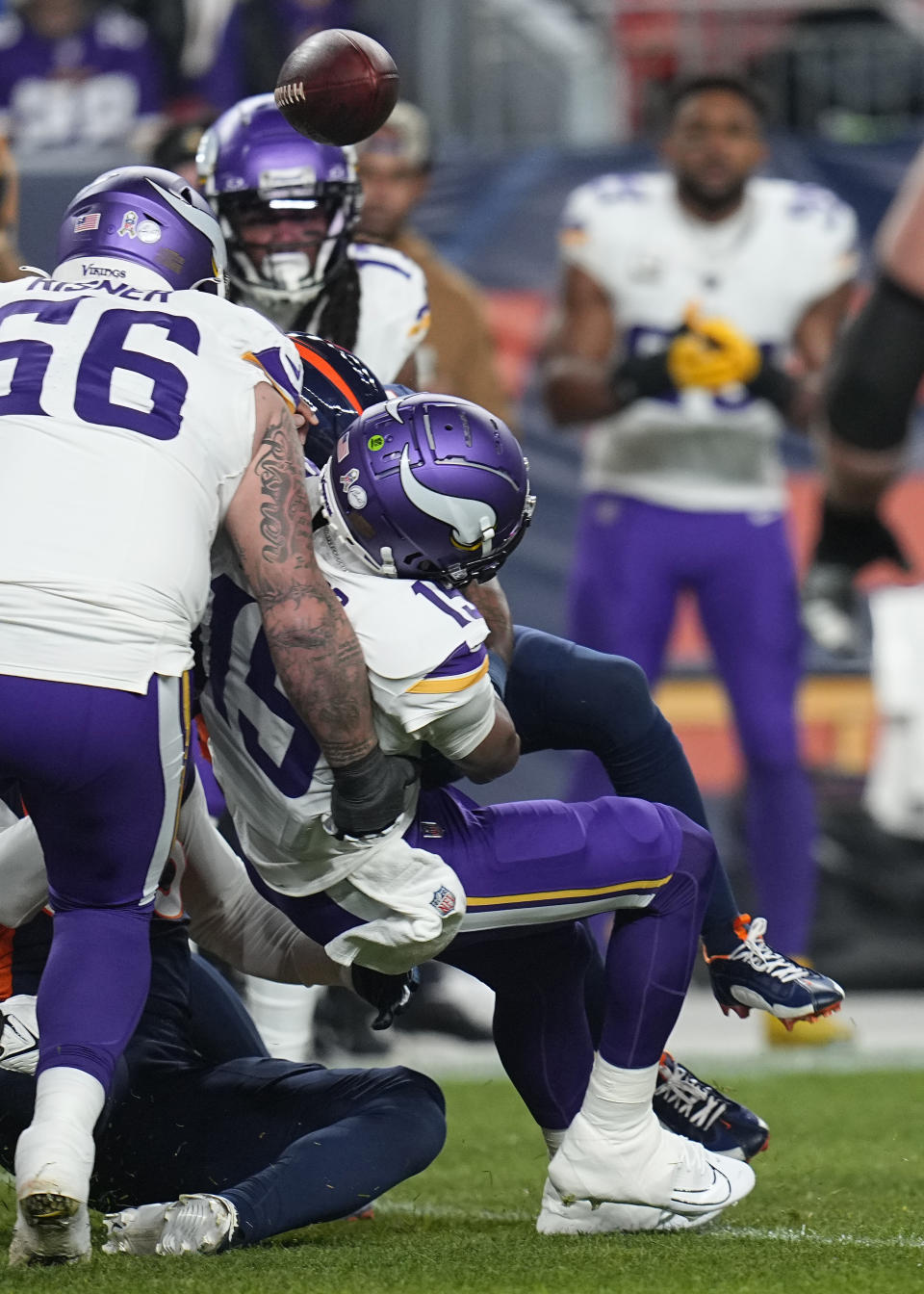 Minnesota Vikings quarterback Joshua Dobbs fumbles the ball during the first half on an NFL football game, Sunday, Nov. 19, 2023, in Denver. The Broncos recovered the ball. (AP Photo/Jack Dempsey)