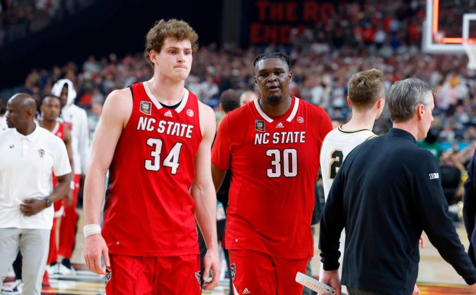 N.C. State’s Ben Middlebrooks (34) and DJ Burns Jr. (30) walk off the court after Purdue’s 63-50 victory over N.C. State in the NCAA Tournament national semifinals at State Farm Stadium in Glendale, Ariz., Saturday, April 6, 2024.