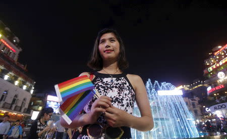 Transgender Anh Phong, 27, who changed her gender from a man to a woman, waits for friends before a LGBT (lesbian, gay, bisexual and transgender) demonstration along a street in Hanoi, Vietnam November 24, 2015. REUTERS/Kham