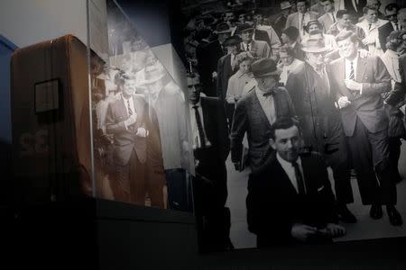 A photograph of John F. Kennedy is displayed next to the suitcase he used in the 1960 Presidential primaries and general election, part of the exhibit "JFK 100," marking the 100th anniversary of Kennedy's birth May 29, at the John F. Kennedy Presidential Library in Boston, Massachusetts, U.S., May 19, 2017. REUTERS/Brian Snyder