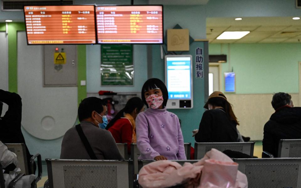 Children and their parents wait in an outpatient area of ​​a children's hospital in Beijing on Nov. 23, 2023.