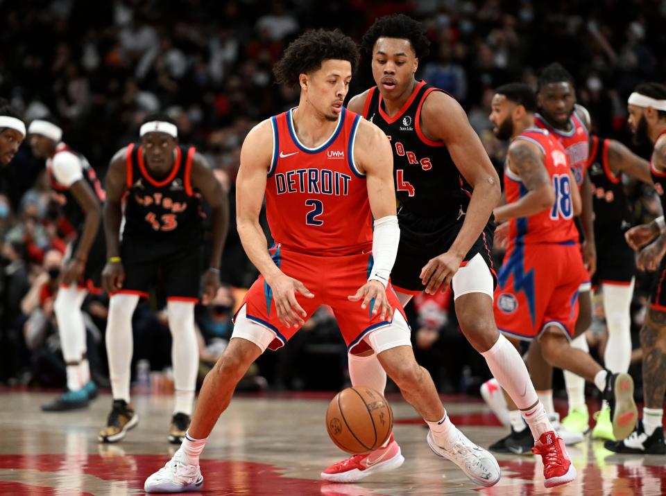 Detroit Pistons guard Cade Cunningham controls the ball in front of Toronto Raptors forward Scottie Barnes in the second half at Scotiabank Arena, March 3, 2022.