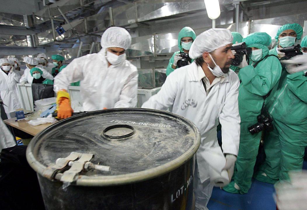 Two technicians carry a box containig uranium ore concentrate, known as yellowcake, at the Uranium Conversion Facility of Iran, just outside the city of Isfahan, 410 kilometers, 255 miles, south of the capital Tehran, Monday, Aug. 8, 2005. Iran resumed uranium conversion activities at the facility Monday. (AP Photo/Mehdi Ghasemi, ISNA)