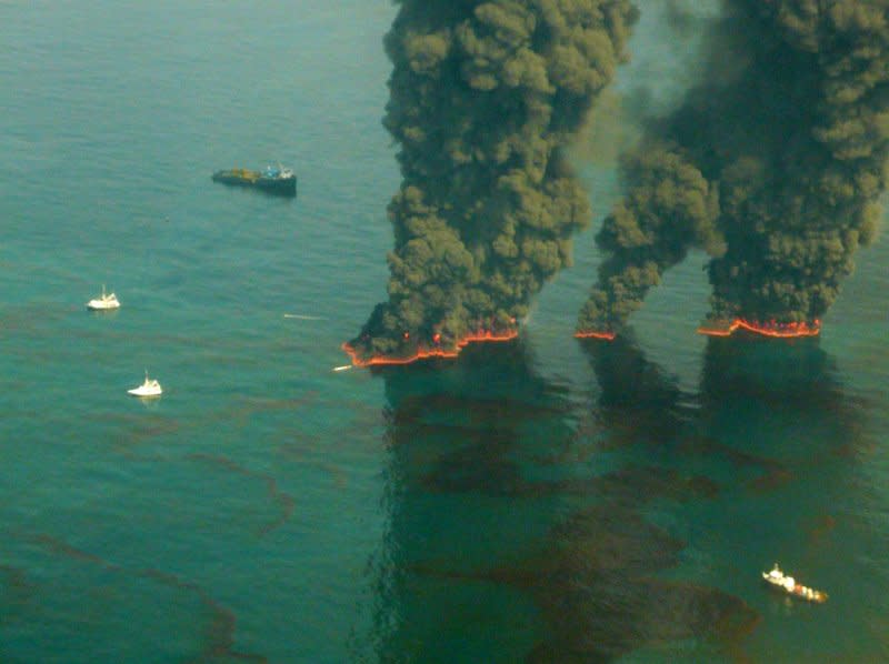 Crews conduct overflights of controlled burns taking place in the Gulf of Mexico on May 19, 2010. On May 15, 2010, the U.S. Environmental Protection Agency gave British oil giant BP the go-ahead to use chemicals in an effort to break up a massive offshore crude oil leak spewing an estimated 70,000 barrels a day into the Gulf of Mexico. File Photo by John Kepsimelis/U.S. Coast Guard