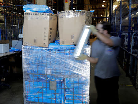 An employee prepares merchandise sold via eCommerce to be delivered to customers at retail chain Magazine Luiza S.A logistics center in Louveira, Brazil April 24, 2018. REUTERS/Paulo Whitaker