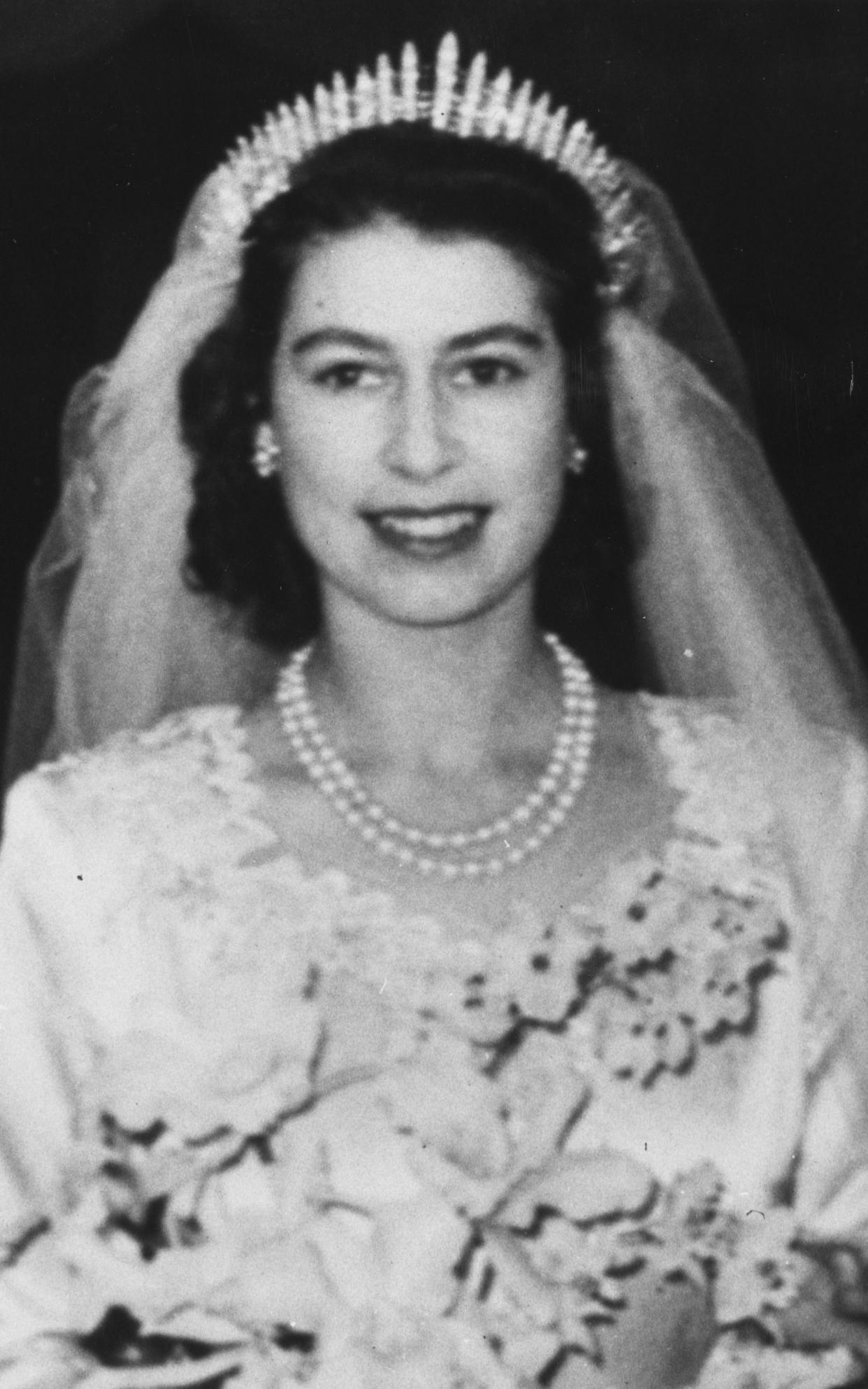 Princess Elizabeth on her wedding day in 1947, wearing a double-strand pearl necklace and a diamond Fringe tiara which was made for Queen Mary, Elizabeth's grandmother. - This content is subject to copyright.