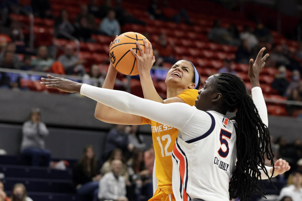 Tennessee guard Rae Burrell (12) is fouled by Auburn guard Aicha Coulibaly (5) as she goes up for a lay up during the first half of an NCAA college basketball game Thursday, Jan. 27, 2022, in Auburn, Ala. (AP Photo/Butch Dill)
