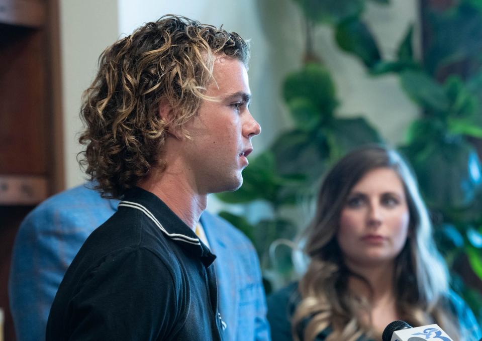 Jordan Gray, right, listens as Matthew Gilley talks during a press conference at the Watson Firm in Pensacola on June 14, 2023.  Gilley, Jordan Gray, and Brandon Gray all tested positive for methamphetamines after eating at Nikko Japanese Steak House and Sushi Bar in Pace on Friday, June 9, 2023.