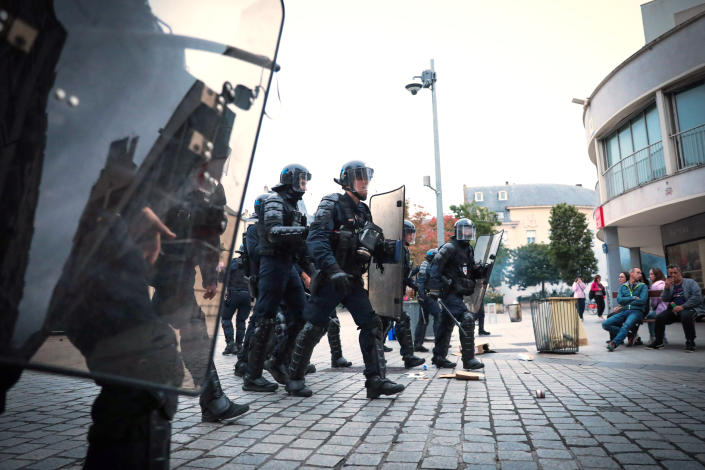 French riot police officers with shields march while patrolling during a demonstration (Lou Benoist / AFP via Getty Images)