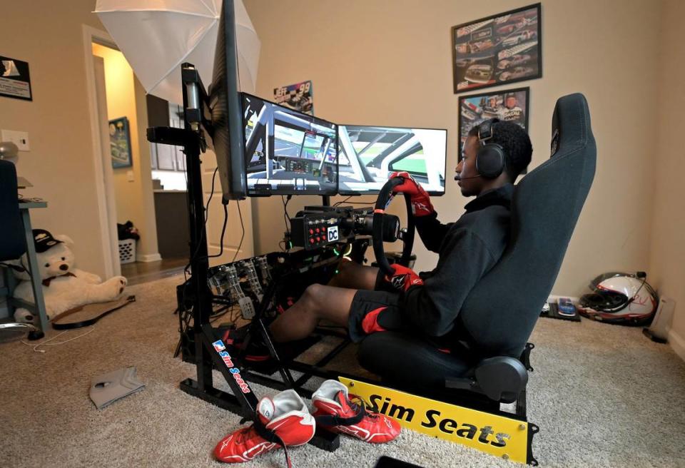 NASCAR driver Rajah Caruth uses his iRacing simulator in his apartment bedroom to compete in a race at Atlanta Motor Speedway on Friday, July 1 2022.