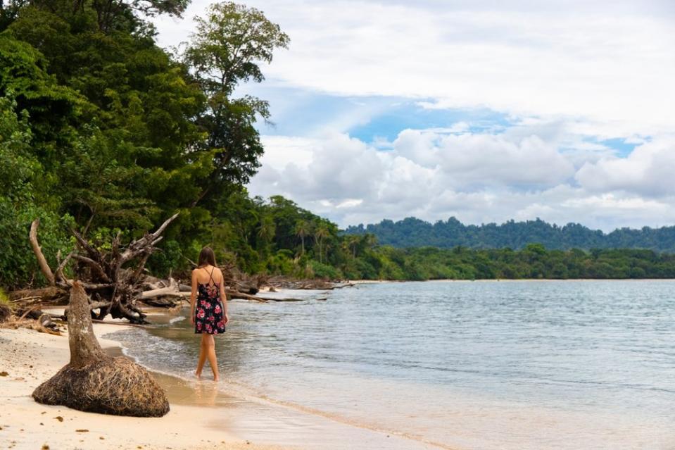 girl walking on Playa Langosta, Costa Rica 