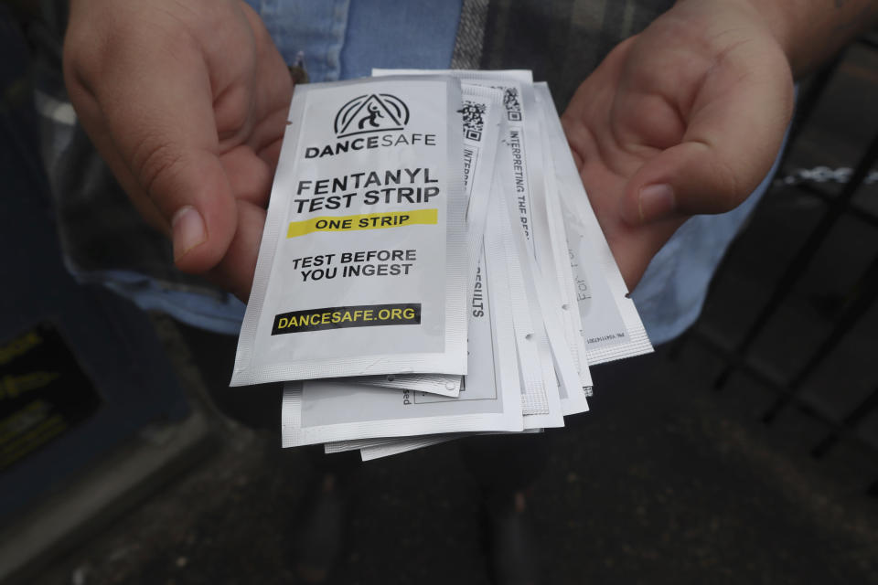 Iris Sidikman, harm reduction coordinator at the Women's Health Center of West Virginia, holds fentanyl testing strips the clinic has on hand to give people dealing with substance use disorder in the clinic parking lot on Thursday, Aug. 4, 2023, in Charleston, W.Va. (AP Photo/Leah Willingham)