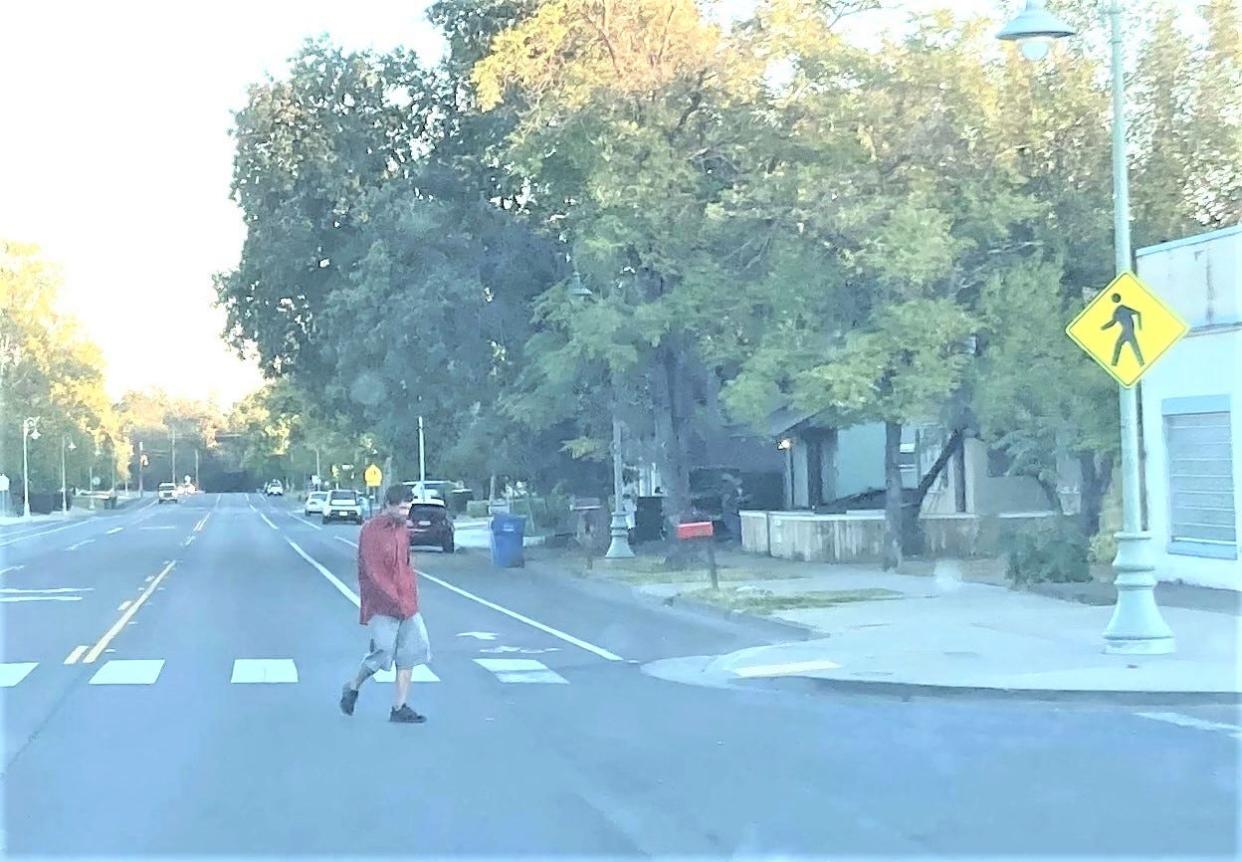 A man walks across Parkview Avenue on Monday, Oct. 3, 2022. Starting next year, it will no longer be illegal in California to cross the street outside a crosswalk.