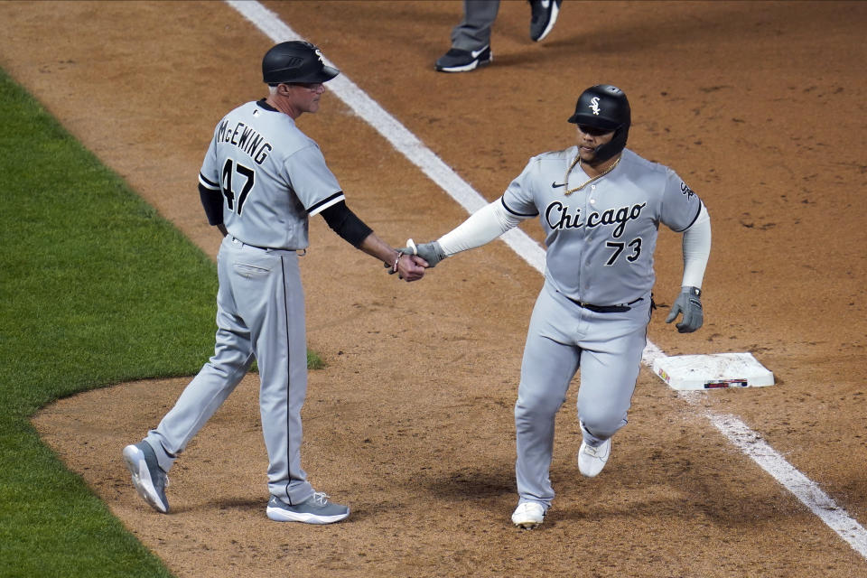 Chicago White Sox's Yermin Mercedes, right, is congratulated by third base coach Joe McEwing after his home run off Minnesota Twins' Willians Astudillo in the ninth inning of a baseball game, Monday, May 17, 2021, in Minneapolis. (AP Photo/Jim Mone)