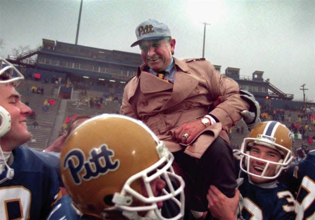 University of Pittsburgh playerd carry coach Johnny Majors off the field after a victory in the 1976 season.