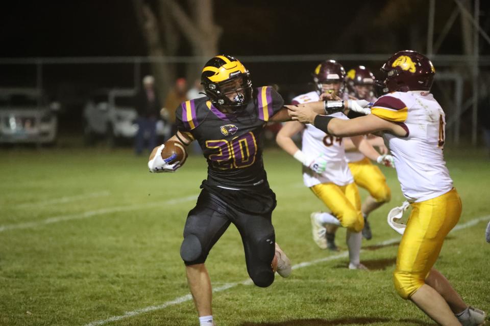 Brenden Begeman (20) stiff arms a De Smet defender in the Class 9A semifinal game in Selby. Begeman, a junior, accounted for 1,720 rushing yards with 24 rushing touchdowns on 208 carries this year. Through the air, Begeman caught 34 passes for 570 yards and nine touchdowns.