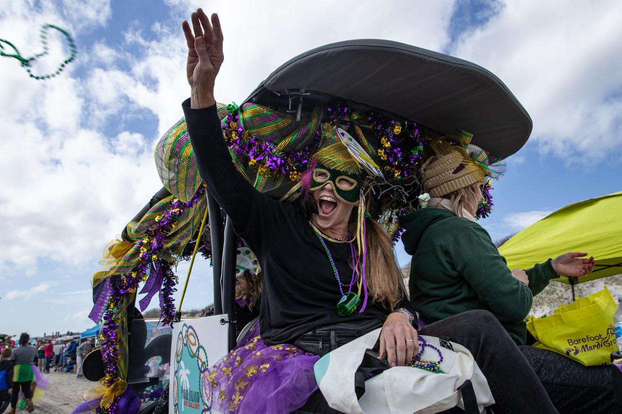 Hundreds of people attend the Barefoot Mardi Gras Parade on North Padre Island, Saturday, Feb. 18, 2023, in Corpus Christi, Texas.