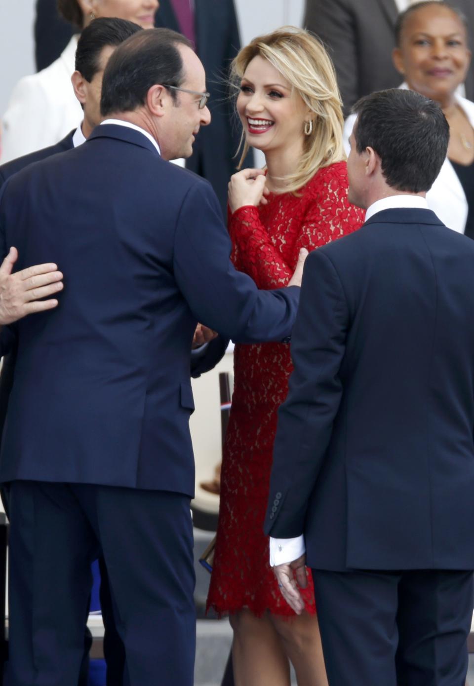French President Francois Hollande greets Mexico's President Enrique Pena Nieto and Mexico's First Lady Angelica Rivera at the start of the traditional Bastille Day military parade in Paris