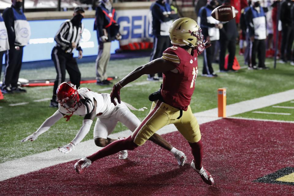 Boston College wide receiver CJ Lewis (11) makes a touchdown reception against Louisville cornerback Kei'Trel Clark during the second half of an NCAA college football game, Saturday, Nov. 28, 2020, in Boston. (AP Photo/Michael Dwyer)