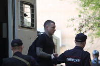 Russian soccer player Pavel Mamayev, who is charged with a brutal assault and held in custody, walks out of a truck before a court hearing in Moscow, Russia May 6, 2019. REUTERS/Evgenia Novozhenina