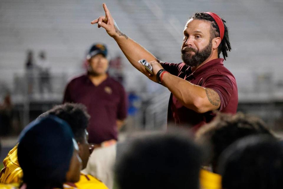 West Charlotte’s head coach Sam Greiner speaks to the team after a game against Garinger at Waddell High School in Charlotte, N.C., Thursday, Sept. 8, 2022. West Charlotte beat Garinger 48-8.