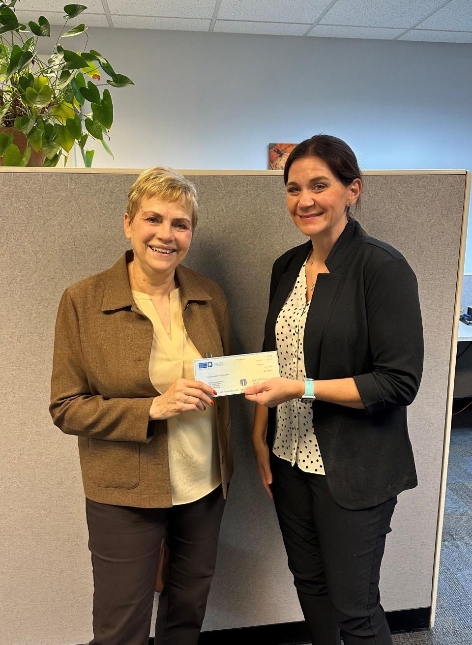 Kathleen Russeau, executive director of Community Foundation of Monroe County (left), is shown with Christi Rogers, director of Child Advocacy Network (CAN Council) of Monroe County. CAN Council was one of three organizations to receive Monroe Health Plan Endowment Fund grants recently.