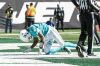 Miami Dolphins quarterback Teddy Bridgewater (5) is knocked down on the Dolphins first offensive play of an NFL game against the New York Jets on Sunday, Oct. 9, 2022, in East Rutherford, N.J. Bridgewater left the game with what the team said was an elbow injury and he was also being evaluated for a concussion. (Andrew Mills/NJ Advance Media via AP)