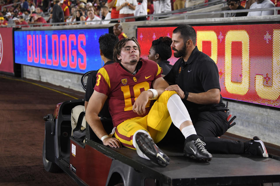 Southern California quarterback JT Daniels is carted off the field after being injured during the first half of an NCAA college football game against Fresno State Saturday, Aug. 31, 2019, in Los Angeles. (AP Photo/Mark J. Terrill)