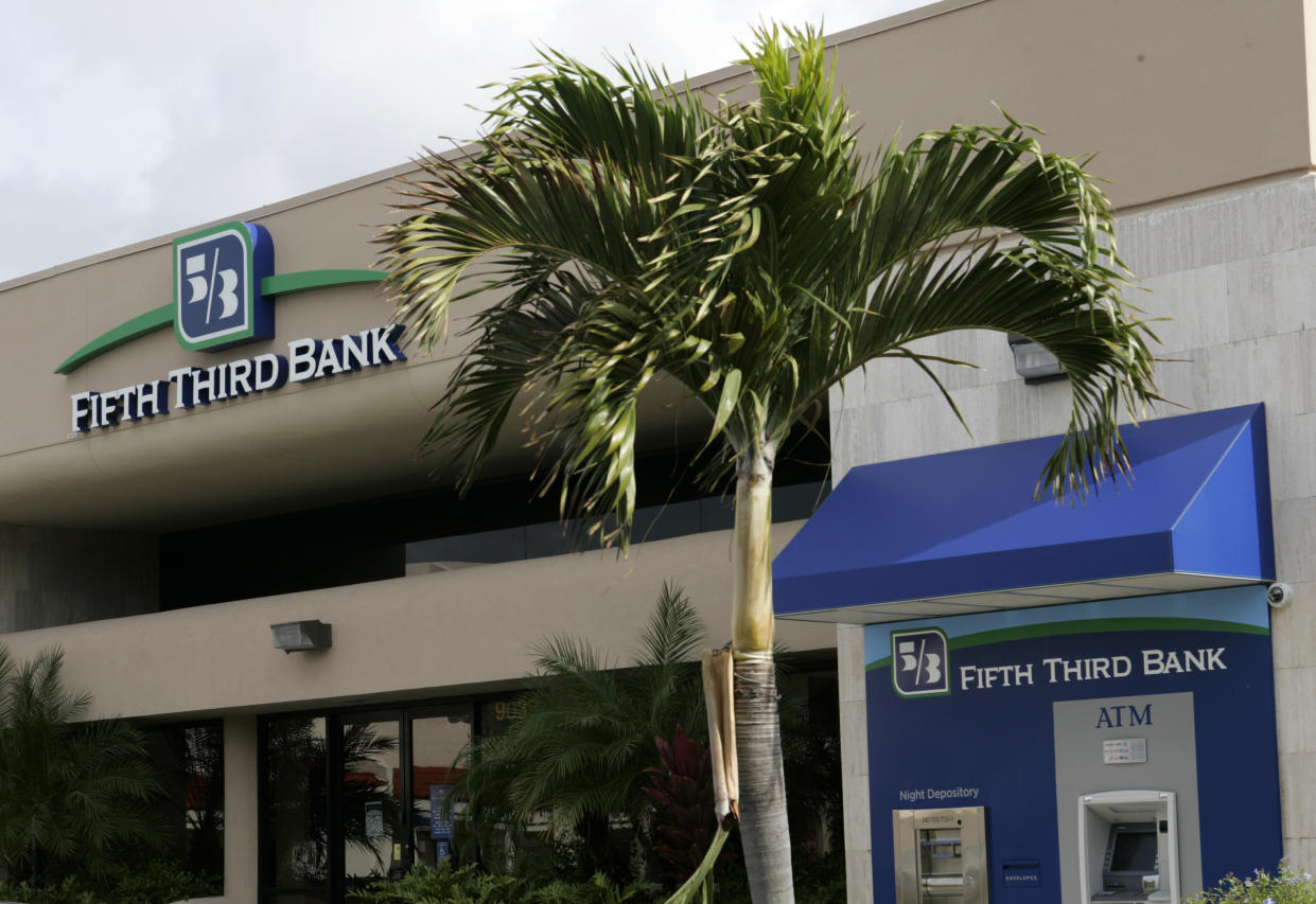 A storefront of a Fifth Third bank branch is shown with a palm tree in Florida.