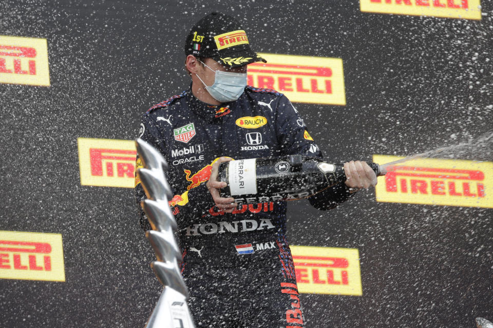 Red Bull driver Max Verstappen of the Netherlands celebrates his victory on the podium of the Emilia Romagna Formula One Grand Prix, at the Imola racetrack, Italy, Sunday, April 18, 2021. (AP Photo/Luca Bruno)