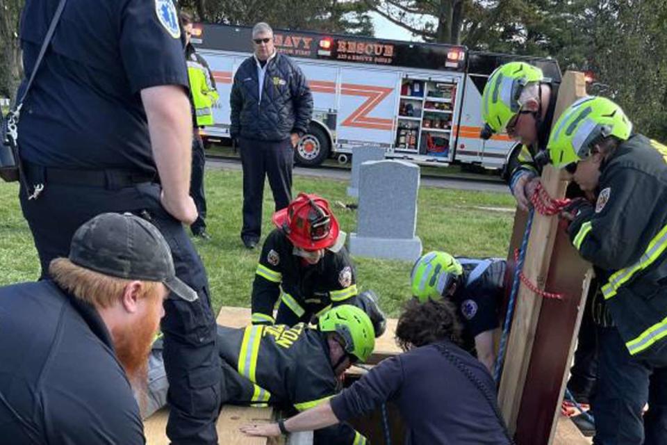 <p>South Brunswick Police Department</p> First responders work to rescue a cemetery worker in New Jersey