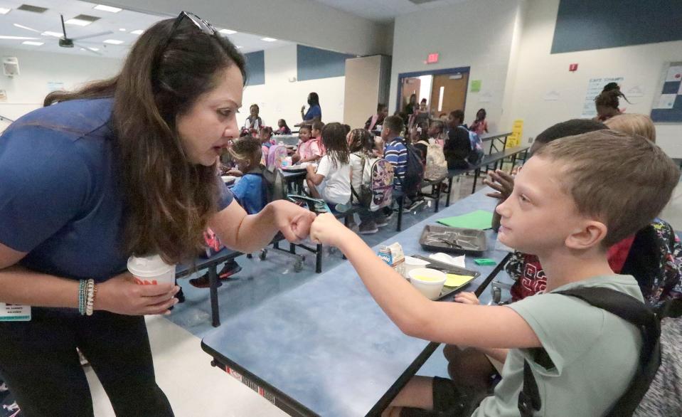 New Volusia County Schools Superintendent Carmen Balgobin visits with fourth-grader Jimmy Griffin and other students over breakfast on Monday at Palm Terrace Elementary School in Daytona Beach. It was the first day of classes for roughly 63,000 students in Volusia County. "Compared with the past 2-1/2 years, this has to be a more normal year, so students can focus on learning and teachers can focus on teaching,” Balgobin said, “so everyone can focus really on what it’s all about.”