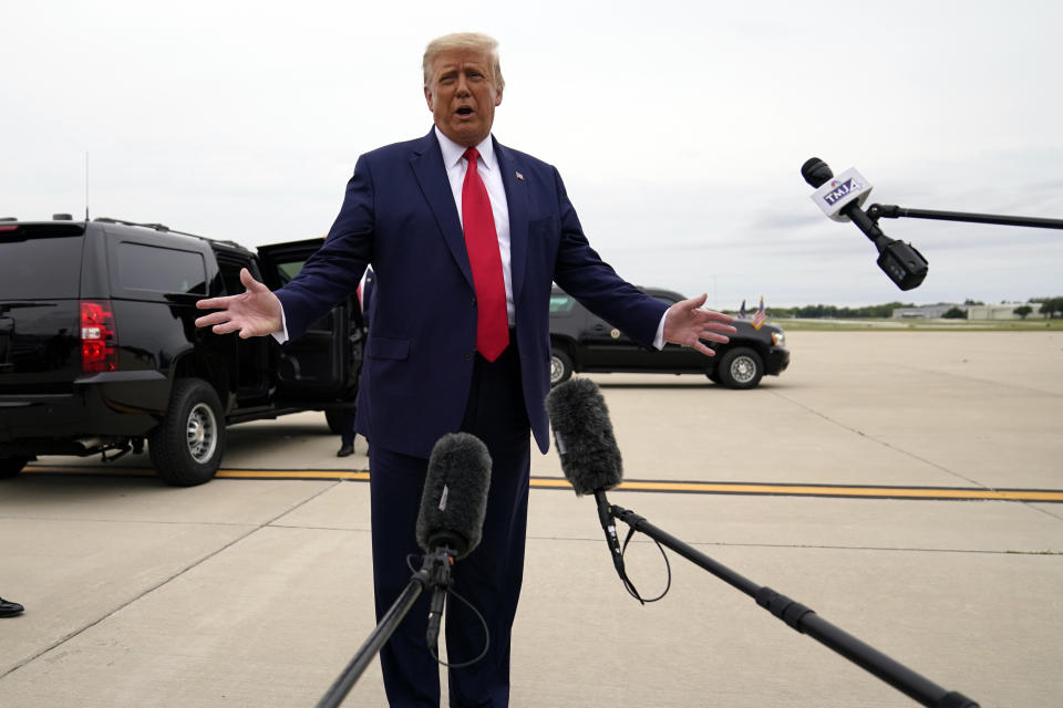 President Donald Trump talks to reporters as he arrives at Waukegan National Airport in Waukegan, Ill., on his way to visit Kenosha, Wis., Sept. 1, 2020, in Kenosha. (AP Photo/Evan Vucci)