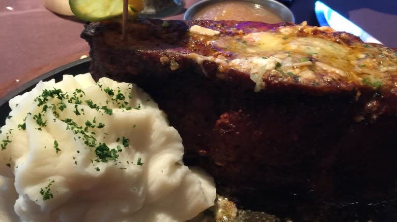 steak with mashed potatoes on black plate