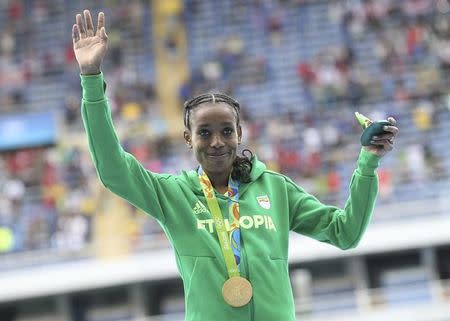 2016 Rio Olympics - Athletics - Victory Ceremony - Women's 10,000m Victory Ceremony - Olympic Stadium - Rio de Janeiro, Brazil - 12/08/2016. Gold medallist Almaz Ayana (ETH) of Ethiopia poses with her medal. REUTERS/Alessandro Bianchi