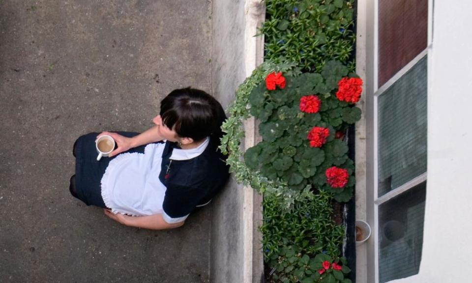 A maid has a coffee break in the basement of a London hotel