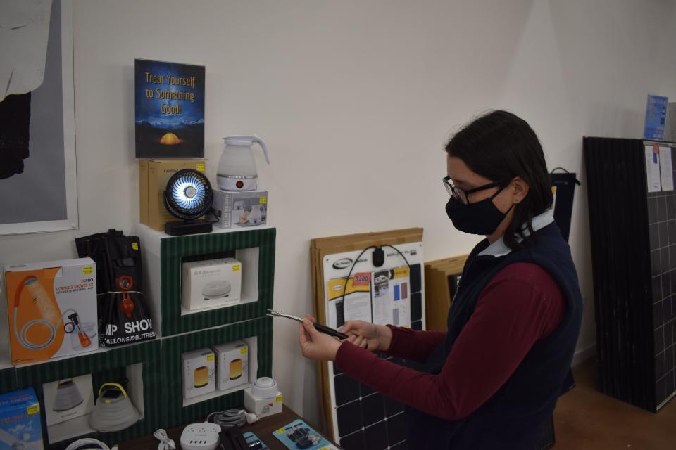 Marshall Off Grid Store owner Samantha Flake holds a USB-powered lighter, just one of the items on sale at the downtown Marshall store.