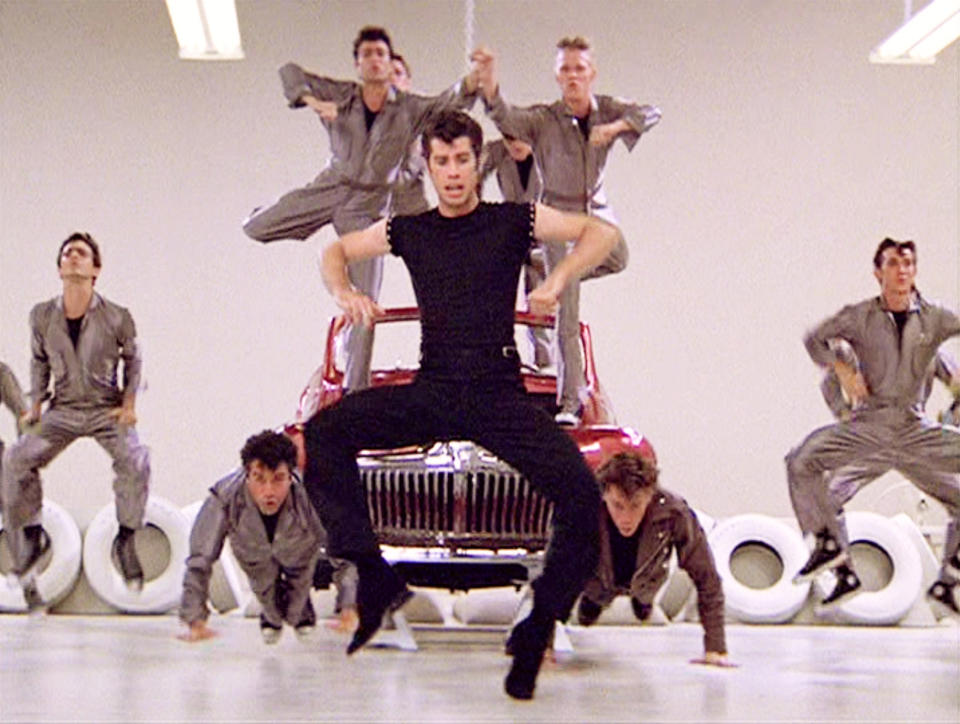 LOS ANGELES - JUNE 16: The movie "Grease", directed by Randal Kleiser. Seen here, the musical number,  "Greased Lightning," led by John Travolta (front and center) as Danny Zuko. Initial theatrical release of the film, June 16, 1978. Screen capture. Paramount Pictures. (Photo by CBS via Getty Images)