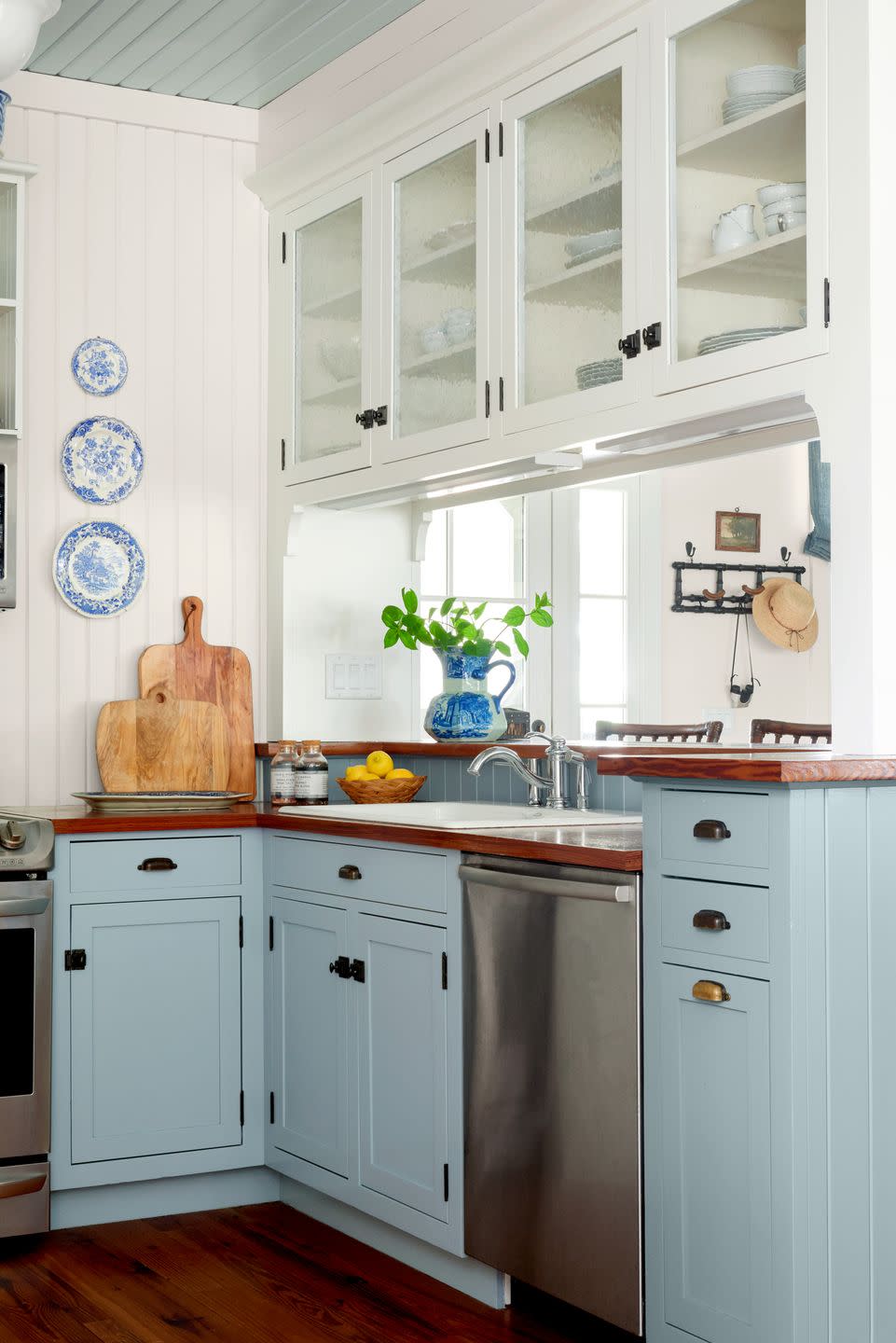 small white kitchen with blue cabinets