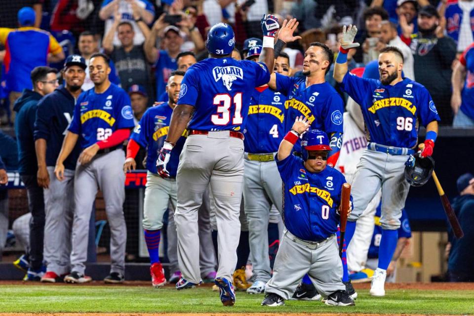 Venezuela base runner Yasiel Puig (31) reacts with teammates after homering to left field during the eighth inning of a Caribbean Series baseball game at loanDepot park in Miami, Florida, on Thursday,February 1, 2024.