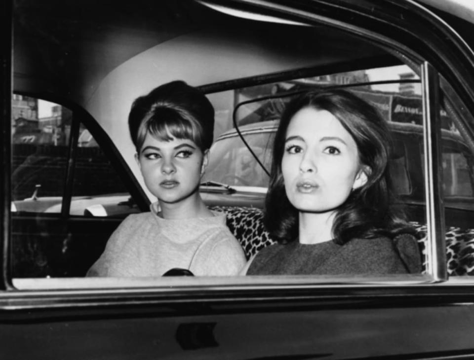 Mandy Rice-Davies (left) and Christine Keeler, witnesses in the Profumo Scandal, pictured in the back of a car as they leave court following the trial of Stephen Ward, at the Old Bailey, London, June 22nd 1963.