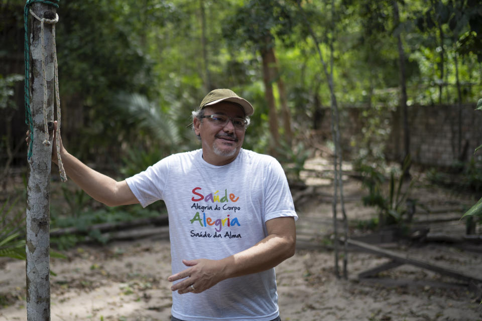 In this Dec. 1, 2019 photo, Caetano Scannavino, coordinator of NGO "Saude e Alegria," or Health and Happiness, gives an interview outside his home in Alter do Chao, Para state, Brazil. The sleepy Amazon town has become the flashpoint for the growing hostility between Brazil’s far-right President Jair Bolsonaro and environmental groups following the arrest of firefighters he says set rainforest fires. (AP Photo/Leo Correa)
