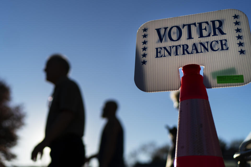 FILE - Voters pass a sign outside a polling site in Warwick, R.I.,, on Nov. 7, 2022, after casting their ballots on the last day of early voting before the midterm election. Almost half of all voters in the 2022 midterm elections cast their ballots before Election Day either by mail or through early voting, with Asian and Hispanic voters leading the way, new data from the U.S. Census Bureau released Tuesday, May 2, 2023, shows, even as Republican-led states have tightened rules on voting by mail. (AP Photo/David Goldman, File)