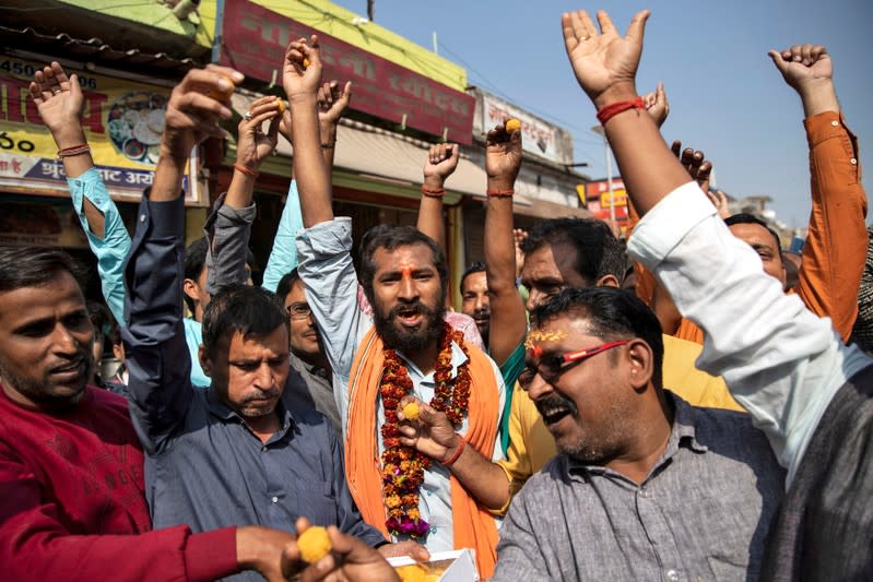 Hindu devotees celebrate after Supreme Court's verdict on a disputed religious site, in Ayodhya