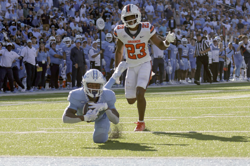 North Carolina wide receiver Nate McCollum (6) tumbles into the end zone for a touchdown as Syracuse defensive back Jayden Bellamy (23) looks on during the first half of an NCAA college football game against North Carolina, Saturday, Oct. 7, 2023, in Chapel Hill, N.C. (AP Photo/Chris Seward)