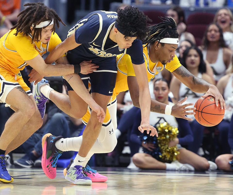 Kent's Jalen Sullinger, left, and VonCameron Davis, right, go after a loose ball with Akron's Enrique Freeman in a MAC Tournament quarterfinal Friday, March 10, 2023, in Cleveland.