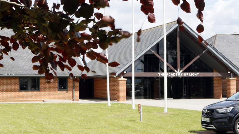 The outside of Sunderland's training facility - a one story building with a sign on the door saying Academy of Light 